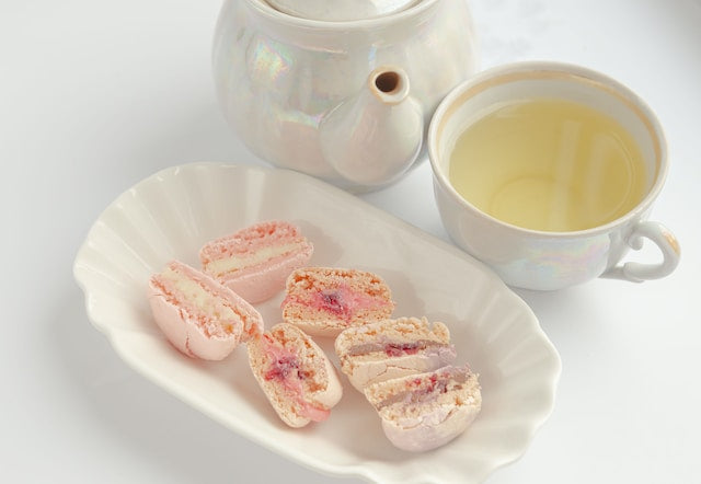 White tea served in a ceramic mug and pairing sweets